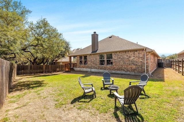 view of yard featuring a fire pit and a fenced backyard