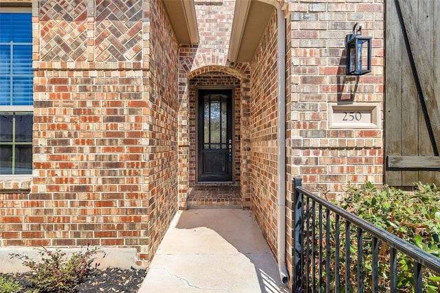 property entrance featuring brick siding