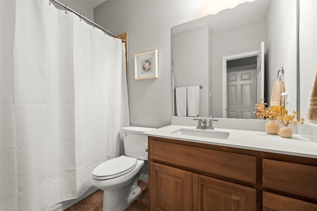 bathroom featuring toilet, vanity, and a shower with shower curtain