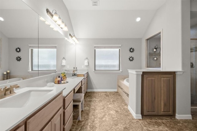 bathroom featuring a sink, visible vents, lofted ceiling, and a wealth of natural light