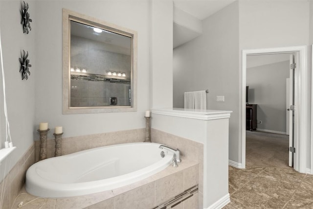 bathroom with baseboards and a garden tub