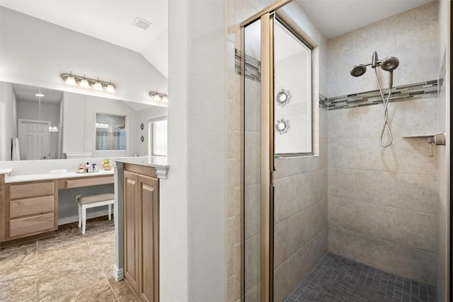 bathroom with a shower stall and vanity