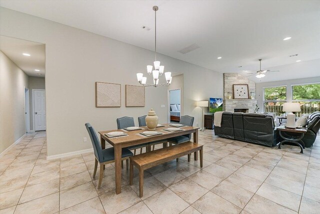 dining room with ceiling fan with notable chandelier, visible vents, recessed lighting, a fireplace, and light tile patterned floors