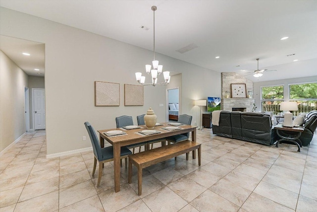 250 Nantucket Cir, Austin, TX 78737 - dining space with ceiling fan, a stone fireplace, a chandelier, recessed lighting, and light tile patterned floors