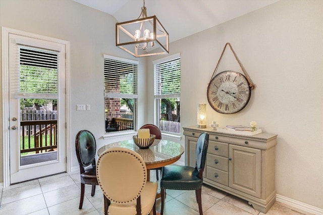 dining room featuring light tile patterned floors, a chandelier, and baseboards
