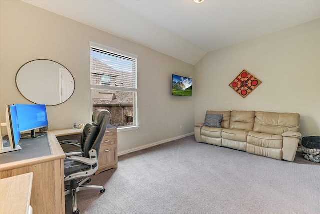 carpeted home office featuring baseboards and vaulted ceiling