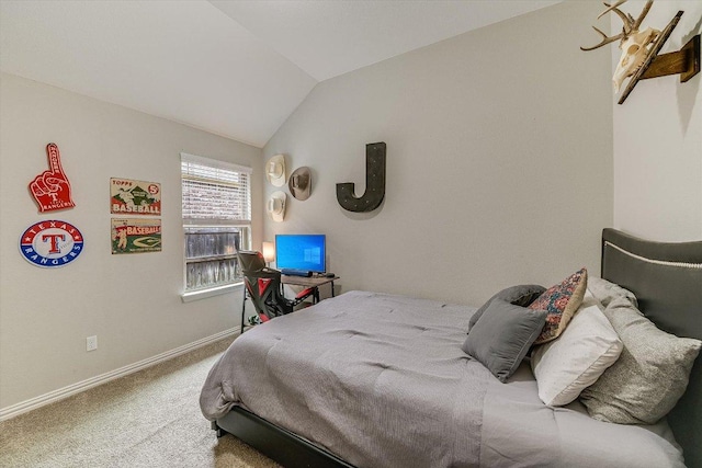 carpeted bedroom featuring vaulted ceiling and baseboards