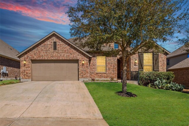 250 Nantucket Cir, Austin, TX 78737 - view of front of home with driveway, a front lawn, brick siding, and an attached garage