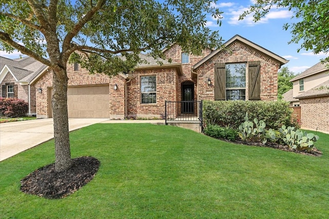 view of front of property with an attached garage, brick siding, driveway, and a front yard