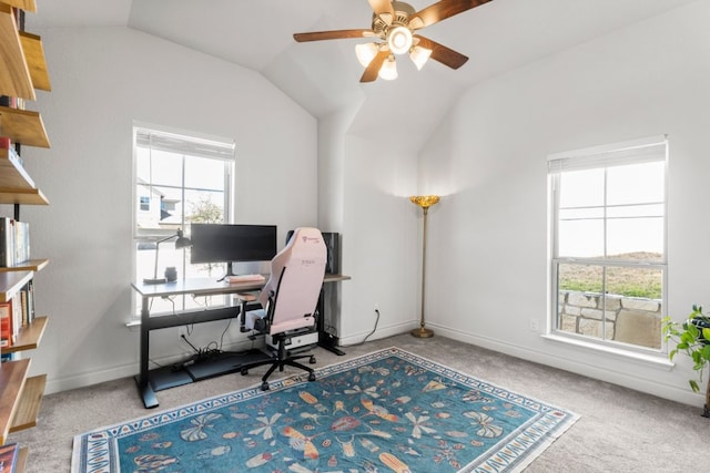 carpeted office featuring baseboards, lofted ceiling, and ceiling fan