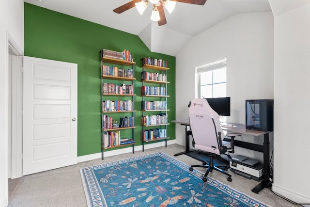 carpeted office space with baseboards, lofted ceiling, and a ceiling fan