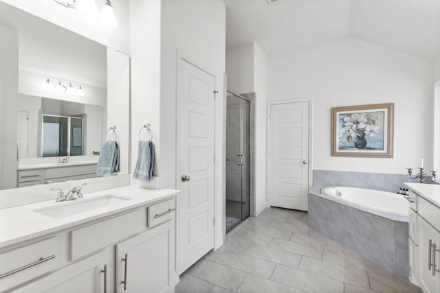 bathroom featuring a bath, a shower stall, vanity, and lofted ceiling