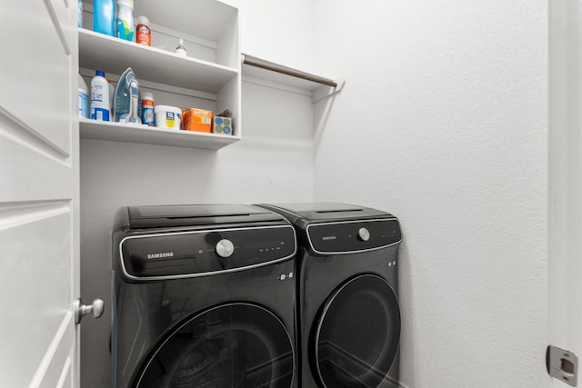 washroom featuring laundry area and washing machine and clothes dryer