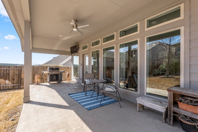 view of patio / terrace with grilling area, ceiling fan, and fence