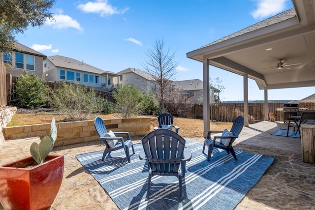 view of patio / terrace featuring a ceiling fan, a fenced backyard, and a residential view