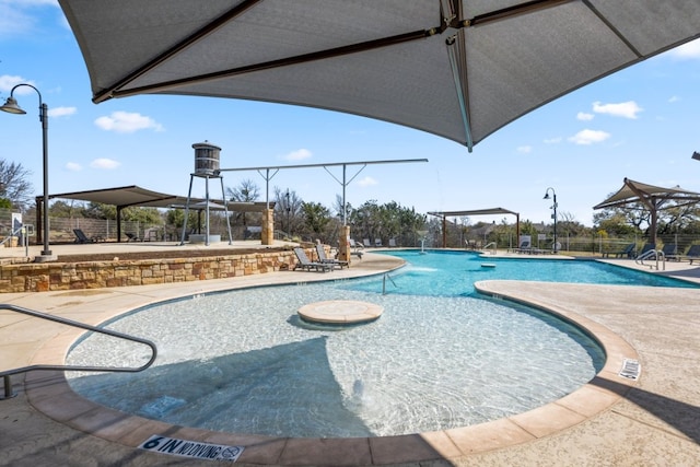 community pool featuring a patio and fence