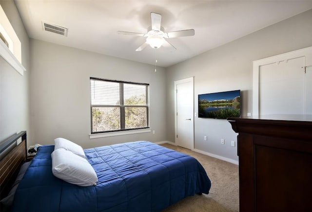 carpeted bedroom with baseboards, visible vents, and ceiling fan