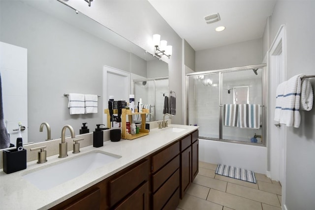 bathroom featuring tile patterned floors, visible vents, shower / bath combination with glass door, and a sink