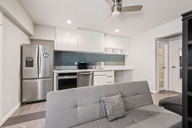 kitchen featuring white cabinetry, tasteful backsplash, appliances with stainless steel finishes, and ceiling fan