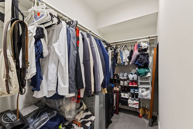 walk in closet with tile patterned floors