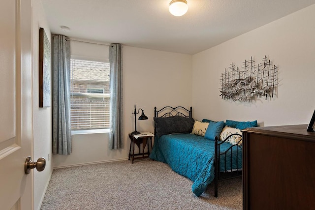 carpeted bedroom featuring baseboards