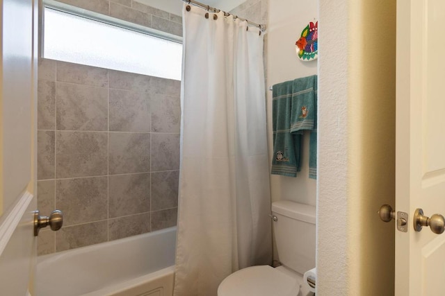 bathroom featuring toilet and shower / tub combo with curtain