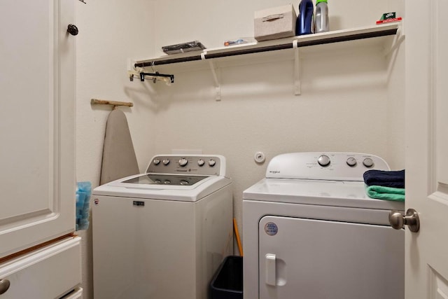 clothes washing area with washing machine and dryer and laundry area