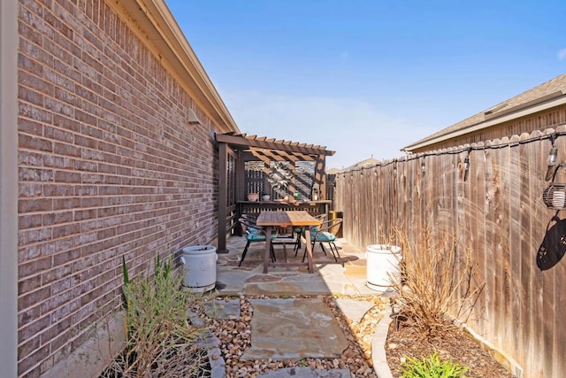 view of patio / terrace with a pergola, outdoor dining area, and fence