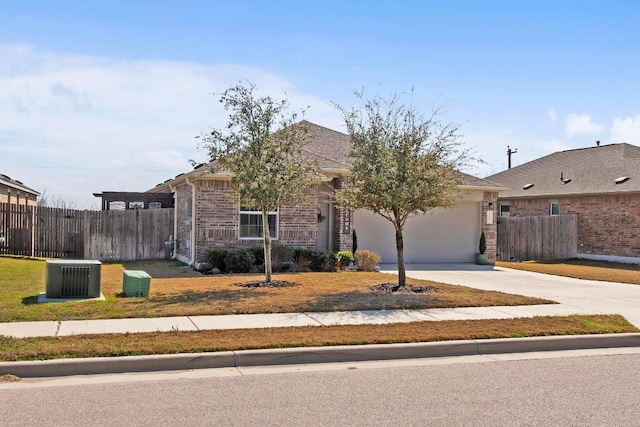 ranch-style house featuring concrete driveway, an attached garage, fence, and brick siding