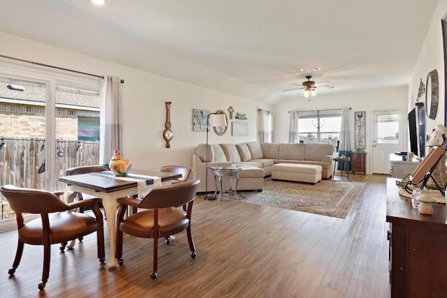 dining area featuring vaulted ceiling, wood finished floors, visible vents, and ceiling fan