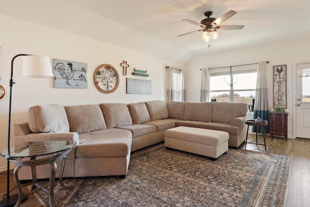 living room featuring vaulted ceiling, wood finished floors, and ceiling fan