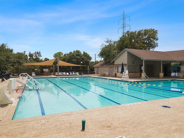 community pool with a patio and fence