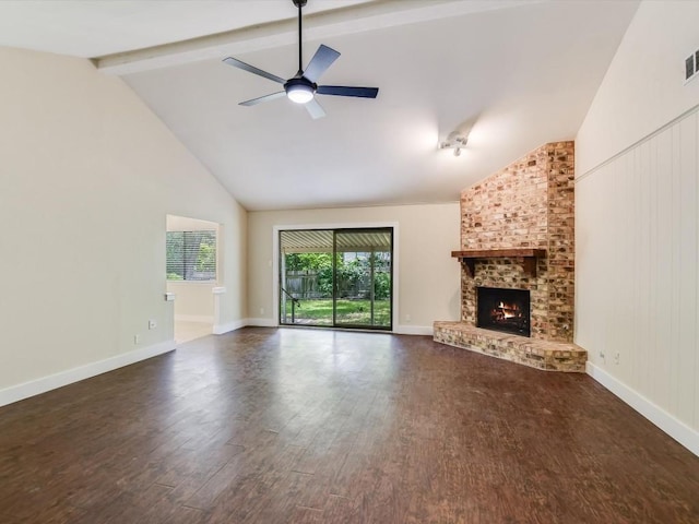 unfurnished living room featuring visible vents, beam ceiling, a fireplace, dark wood-style floors, and a ceiling fan