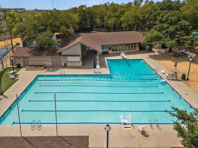 community pool featuring a patio area and fence