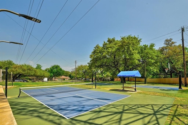 view of sport court featuring fence