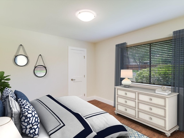 bedroom featuring baseboards and dark wood-style floors