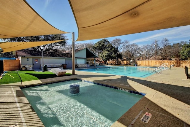 community pool featuring a patio and fence