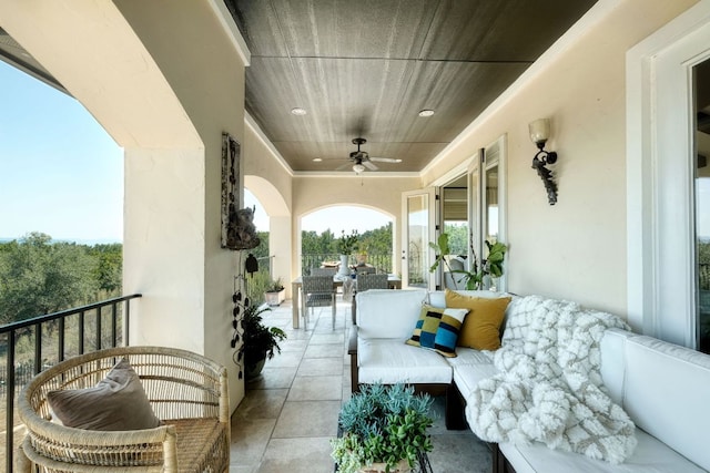 view of patio / terrace with outdoor dining space, a balcony, and a ceiling fan