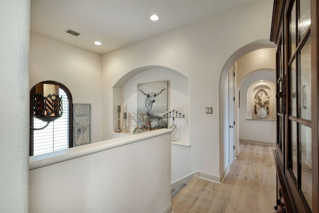 8205 Moon Rise Trl, Jonestown, TX 78645 - hall with light wood-style floors, recessed lighting, arched walkways, and baseboards
