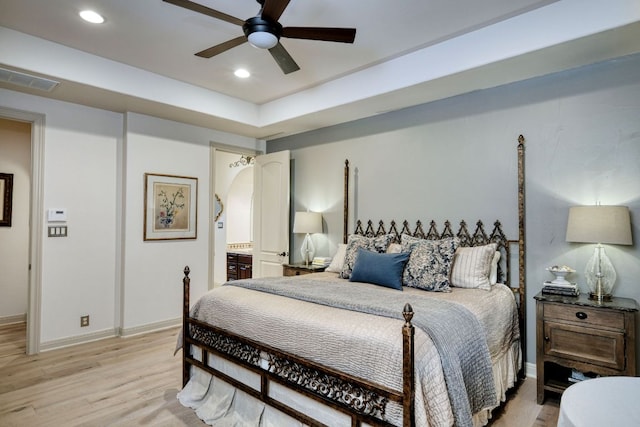 8205 Moon Rise Trl, Jonestown, TX 78645 - bedroom featuring light wood-style flooring, baseboards, recessed lighting, connected bathroom, and a ceiling fan