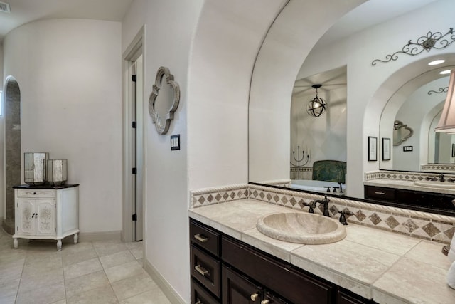 8205 Moon Rise Trl, Jonestown, TX 78645 - bathroom with two vanities, backsplash, tile patterned flooring, and baseboards