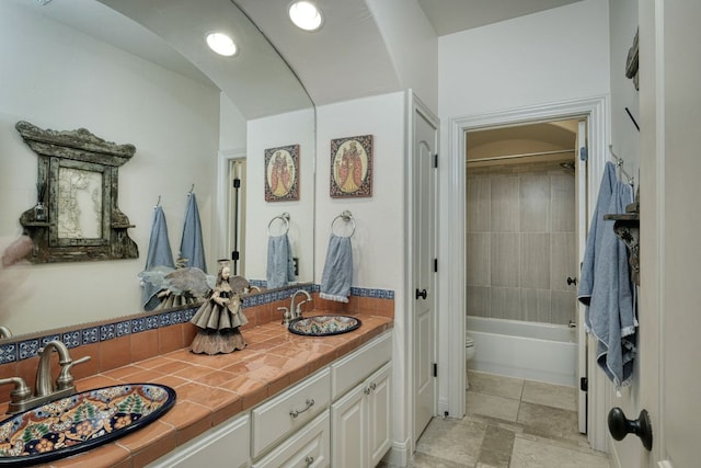 8205 Moon Rise Trl, Jonestown, TX 78645 - full bathroom featuring double vanity, washtub / shower combination, toilet, and recessed lighting