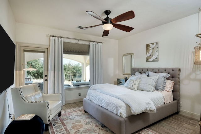 bedroom featuring visible vents, baseboards, ceiling fan, and light wood finished floors