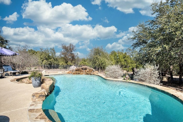 pool featuring a patio and fence