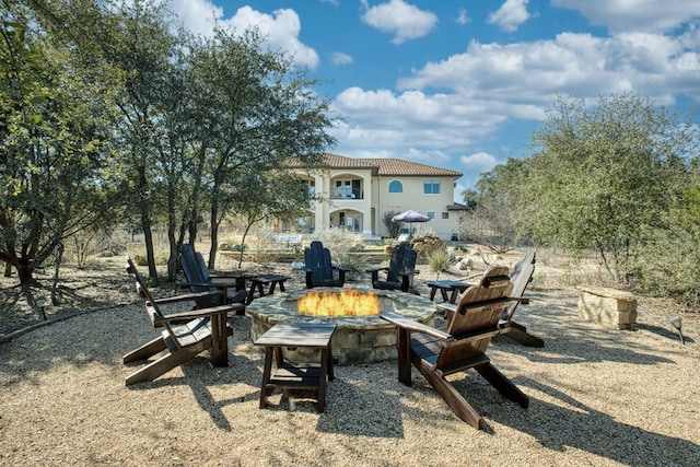 view of yard featuring a balcony and a fire pit