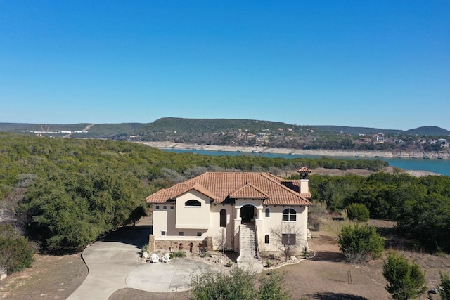 8205 Moon Rise Trl, Jonestown, TX 78645 - view of mountain backdrop featuring a nearby body of water and a forest
