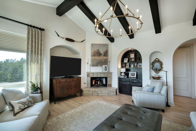 living room with arched walkways, light wood finished floors, lofted ceiling with beams, and an inviting chandelier