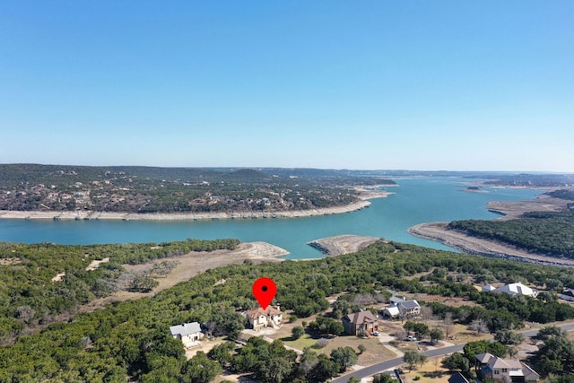 aerial view featuring a forest view and a water view