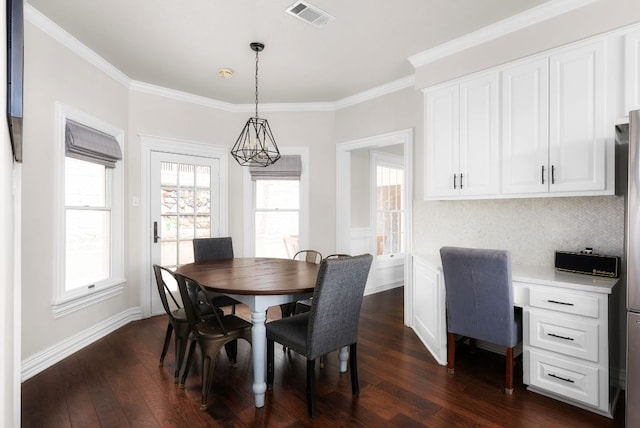 dining area with crown molding, baseboards, visible vents, and dark wood-style flooring