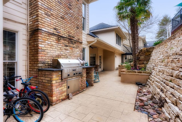 view of patio with grilling area and an outdoor kitchen